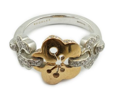 A modern Boodles &amp; Dunthorne two colour 18ct gold and diamond chip set dress ring, size J, gross weight 5.7 grams.**condi