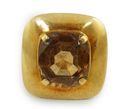 A 1960â€™s? gold and single stone oval cushion cut orange zircon set dress ring, in a broad setting, size L/M, gross weight 9