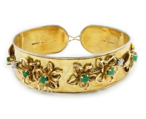 A recent Schwartz 18k gold, emerald and diamond cluster set open bangle with clasp, with raised flower head motifs, gross wei