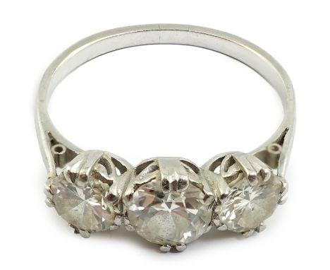 A platinum? and three stone diamond set ring, the central stone diameter approximately 5.7mm, size P, gross weight 3.6 grams.