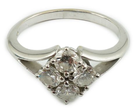 A modern platinum and four stone diamond cluster set ring, the four stones with a total carat weight of 0.97ct, size R, gross