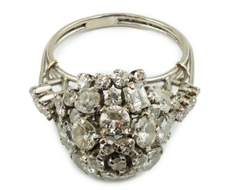A mid 20th century platinum? and diamond cluster set dome shaped dress ring, with diamond set shoulders, set with round and s