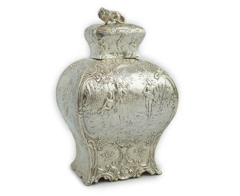 A late 19th century Hanau embossed silver bombÃ© shaped tea caddy and cover, with panels of fete galante scenes, the cover wi