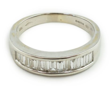 An 18ct white gold and baguette cut diamond channel set half eternity ring, set with approx. 0.70ct diamonds, size P, gross w