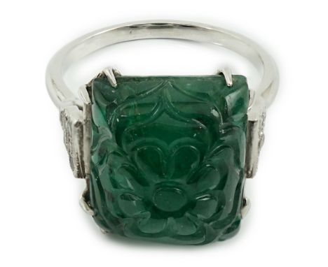 A French 1920's style platinum and single stone emerald set dress ring, with twelve stone millegrain set diamond stepped shou