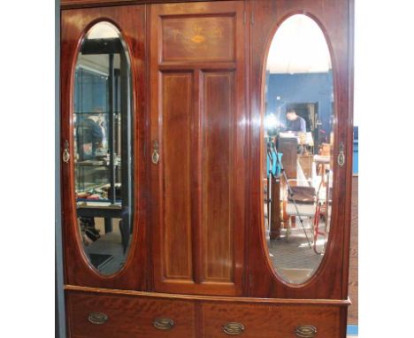 EDWARDIAN MAHOGANY INLAID BEDROOM SUITE
comprising a wardrobe and a dressing table, the wardrobe with three doors, the centra