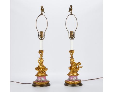 Pair of French old Paris porcelain and gilt bronze cherub lamps. The neck in the form of reeds. The cherubs rest on a porcela