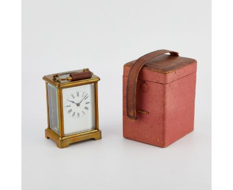 French carriage clock with a brass case enclosing an enamel dial with Roman numeral hour markers. Marked France along the cas