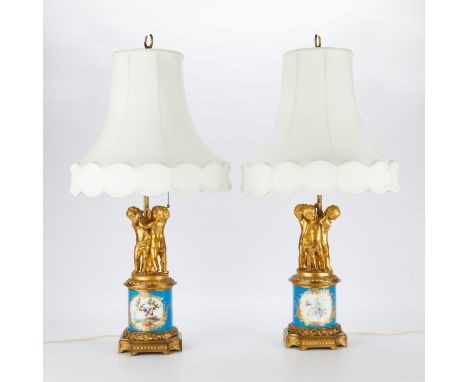 Pair of French old Paris Sevres style porcelain lamps with gilt bronze mounts. The neck in the form of three putti holding th
