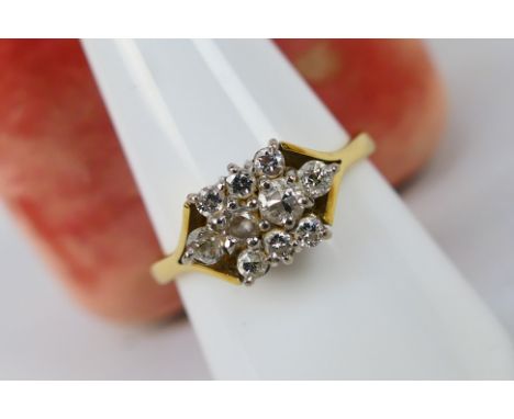 A gold and diamond cluster ring centrally set with four old cut diamonds, including Swiss cut and European cut, measuring fro