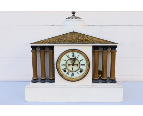An Ansonia Clock Company mantel clock of architectural form, Greek temple foot with six columns, embossed plaque above with b