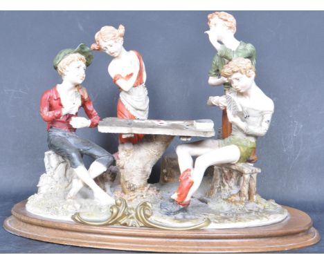 A vintage 20th century Italian Capodimonte bisque group scene featuring four figures playing a game of cards at a table. Sign