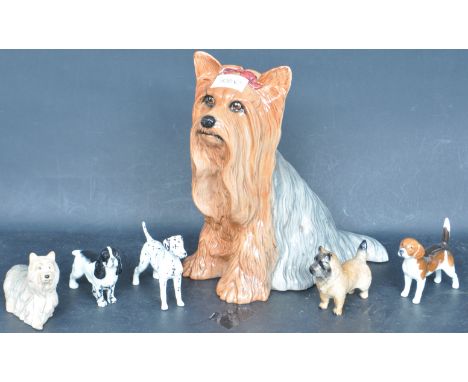A collection of vintage 20th century Beswick china ceramic dog figurines to include a large fireside terrier, a Dalmatian, a 