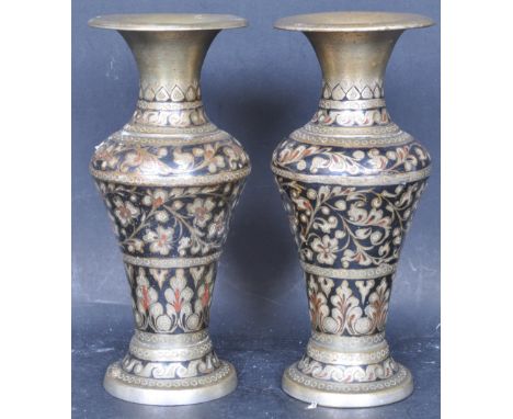 A pair of 20th century Indian brass and black and red enamel vases, each having foliate decoration and flared rim. Measures 1