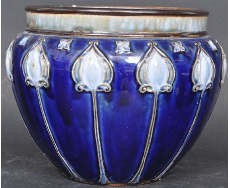 An early 20th century Doulton Lambeth Art Nouveau salt glazed ceramic jardinaire / planter / bowl having a blue background wi