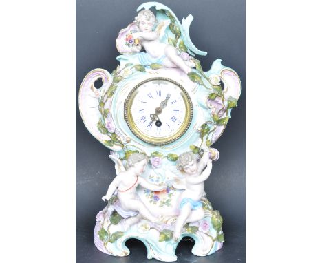 Early 20th century Continental Sitzendorf porcelain mantel clock with inset 24 hour movement. Encrusted with cherub and putti