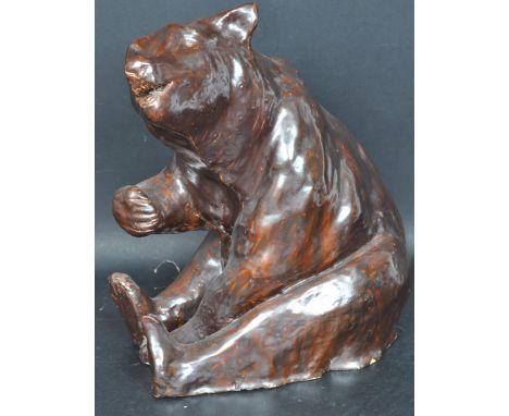 A retro vintage mid 20th century circa 1960s studio art pottery statue of a seated bear decorated in a brown glaze. Measures 