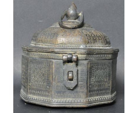 A 19th Century Indian cast metal Paan Daan Betel / spice nut caddy box of round form having a domed lid engraved with florals