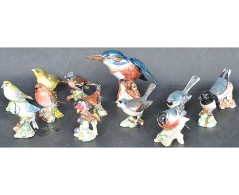 A collection of thirteen vintage 20th century bird figures to include a large Kingfishger figure alongside a robin, a chaffin