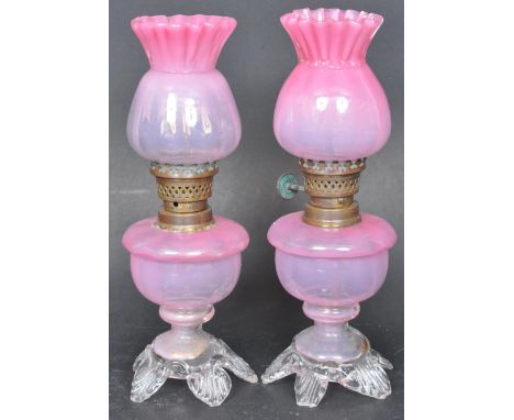 A pair of late Victorian pink vaseline glass fairy oil lamps together with a cranberry / ruby glass perfume atomiser and a sm