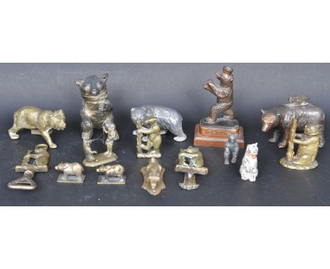 A collection of 20th century brass and other metal bear related figurines comprising of a table lighter, bottle opener, door 