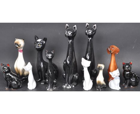 A collection of vintage 20th century ceramic porcelain stylised cat figures to include two stems vases a Dutch dachshund dog 