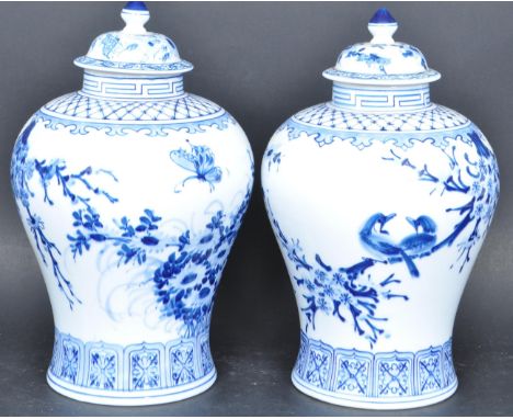 A pair of 20th Century Chinese blue and white porcelain lidded temple jars. The lids / covers having finial to top and the bo