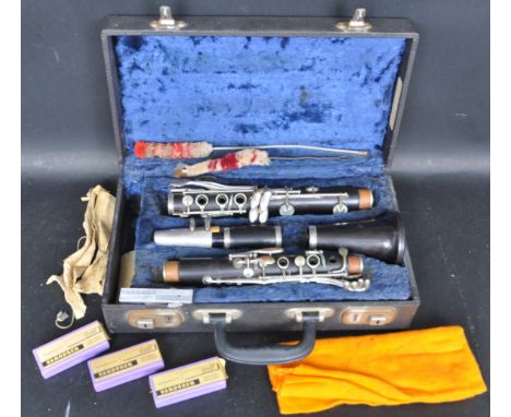 A vintage mid 20th century Boosey &amp; Hawkes of London clarinet musical instrument having a an ebonised shaft with white me