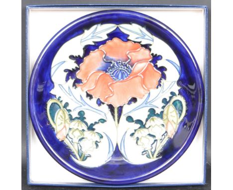 A late 20th century 1990s Moorcroft Blue Anemone plate having polychrome floral decoration to the central surround by a deep 
