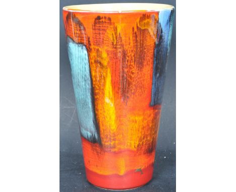 A retro vintage 20th century Poole pottery vase of tapering form in the Volcano pattern decorated in reds, blues and yellows.