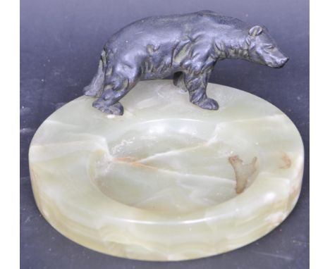 A vintage 20th century onyx and spelter pin tray / ash tray of circular form. The desk top pin tray has a black spelter bear 