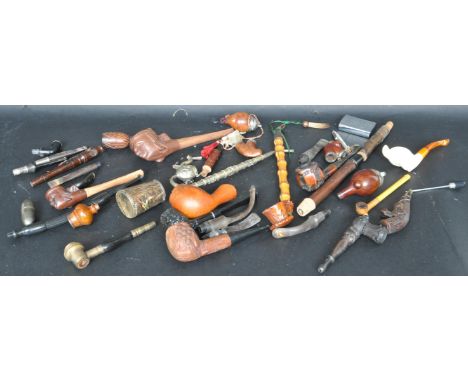 A large collection of vintage 20th century pipes to include novelty examples, metal pipes, carved wooden pipes. a zippo light