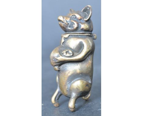A late 20th century vintage brass vesta case in the form of a pig wearing neck tie and holding a pot of money. Match strike t