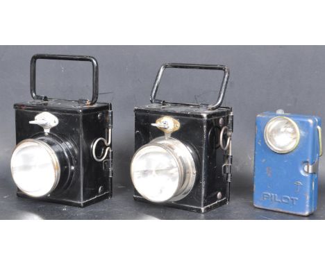 A collection of three vintage mid 20th century metal motorcycles / bicycle lamp comprising of a two ebonised metal cases with