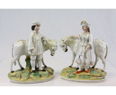Staffordshire pair of ceramic figures of a Boy and Girl, both with Donkey's