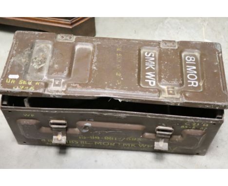 A metal military mortar shell box with various tools