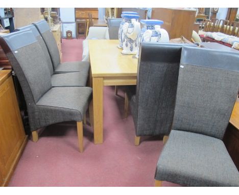 A Modern Light Oak Dining Table, 151 x 90.5cm, together with six fabric and leather dining chairs. (7).Lot 1556 - scratches t