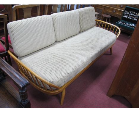 Ercol Day Bed Settee, in the Lucian Ercolani manner, with shaped surfboard back, rail sides on splayed legs, approximately 19