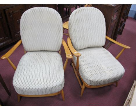 Ercol, pair of light wood low armchairs, each with fleur de lys central splat (no label, re varnished).