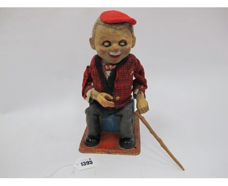 TN Japan Tin Plate Battery Operated Toy, of standing/seated old man on blue trunk, 26cm high when seated.