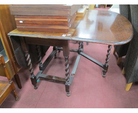 A 1920's Oak Drop Leaf Dining Table, with barley twist supports, gate leg action 151 x 106cm.