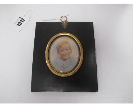 An Early XX Century Portrait Miniature, on ivory of a young boy wearing a blue top, in a gilt and painted back wooden frame, 