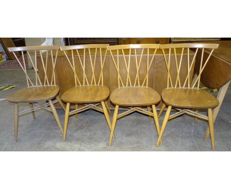 A set of four Ercol 376 candlestick lattice dining chairs together with a low sideboard fitted with three central drawers fla