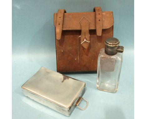 An A &amp; N.C.S. Ltd plated sandwich box and glass flask with plated screw hinged lid, contained in a leather case, (dent to