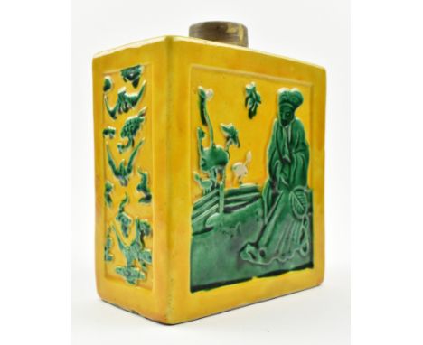 A Qing dynasty susancai tea caddy. The rectangular moulded ceramic tea caddy decorated with a scholar by the lotus pond on bo