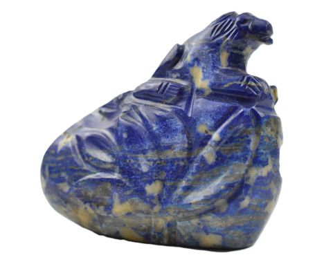 A small lapiz boulder depicts a lion on a rock.Measures approx. 5.5cm tall x 7cm wide