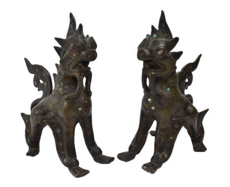 A pair of Chinese cast bronze Qilin in standing position decoated with small blue and red glossy scales . The mouth open in a
