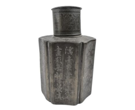 A heavy Qing dynasty pewter tea caddy. The hexagonal lobed shaped tea caddy with a cylindrical neck with cover, decorated wit