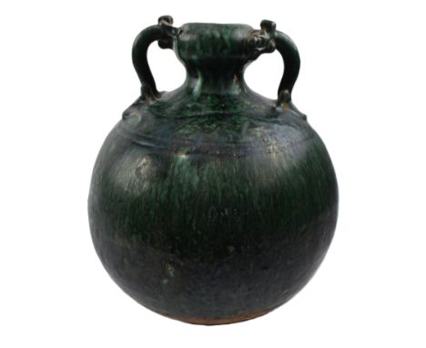 A Chinese green glazed pottery vase. The green glazed bulbous shaped vase with garlic mouth, flanked with Chilong handles and