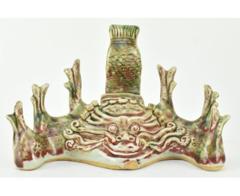 A flambe-glazed ceramic brush holder. The brusher holder modelled in form of a dragon, with fierce eyes, curls in head with h